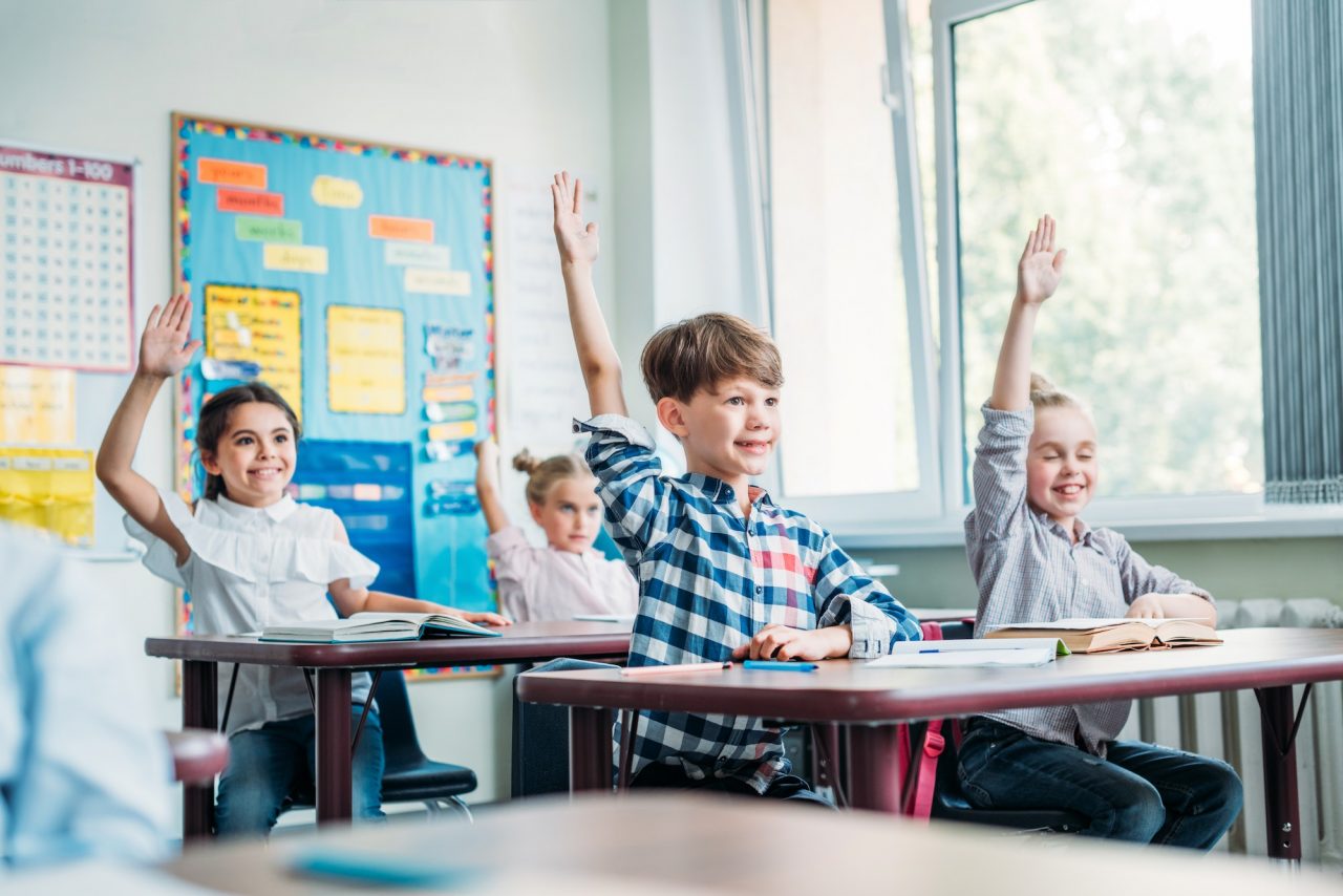 happy-little-kids-raising-hands-in-class.jpg